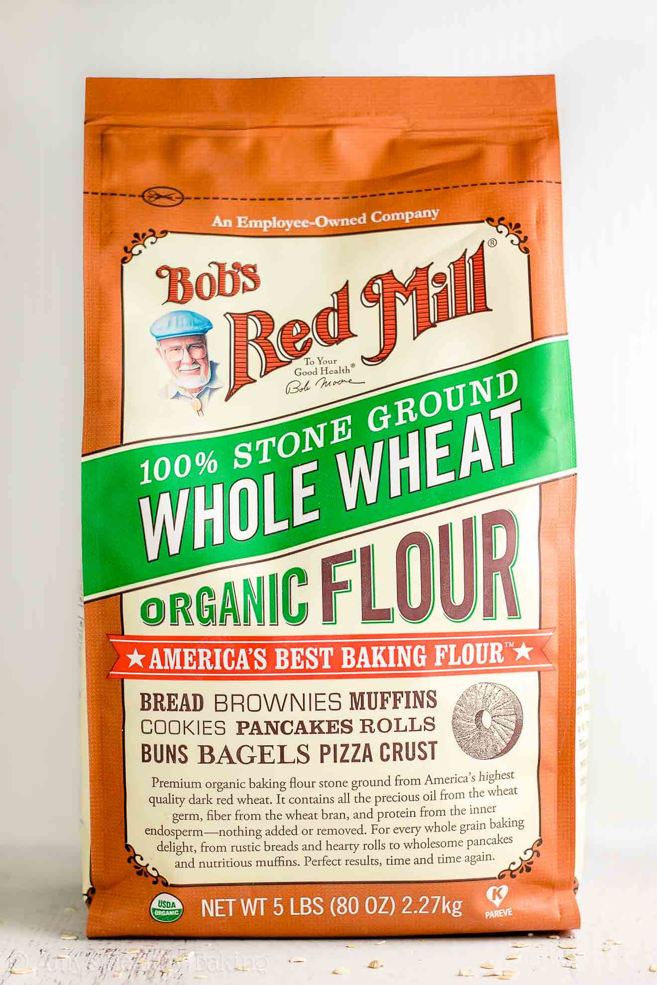 a bag of Bob's Red Mill organic whole wheat flour, about to be turned into a healthy zucchini oatmeal snack cake – easy recipe for a healthy zucchini cake full of oats and spices – low calorie, low fat, soft, moist, and clean eating with whole wheat and gluten free options – made with greek yogurt, pure maple syrup, and no refined sugar