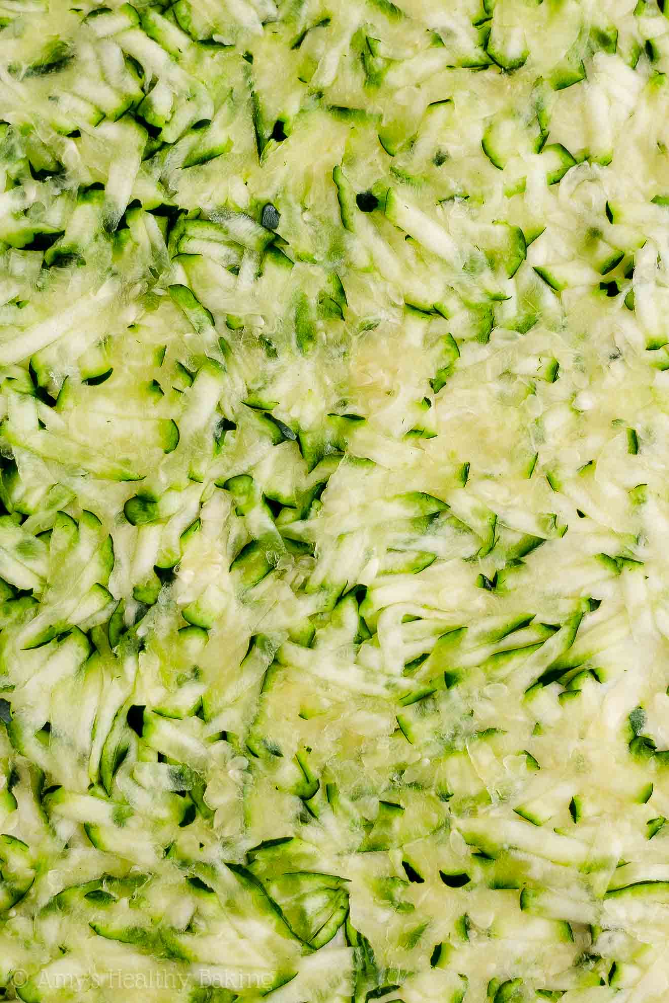 freshly grated zucchini about to be turned into a healthy zucchini oatmeal snack cake – easy recipe for a healthy zucchini cake full of oats and spices – low calorie, low fat, soft, moist, and clean eating with whole wheat and gluten free options – made with greek yogurt, pure maple syrup, and no refined sugar