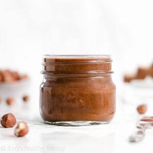 This is the BEST homemade Nutella! This healthy Nutella recipe yields a chocolate hazelnut spread that’s low carb, sugar free, vegan, dairy free, and clean eating. It’s also just as sweet and creamy as the original! Turn this DIY Nutella into easy healthy desserts like cookies, brownies, or truffles. It’s perfect for making sugar free desserts and other healthy sweet treats! Save this simple 4 ingredient recipe for how to make Nutella at home!