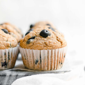 Looking for healthy breakfast recipes? These healthy blueberry oatmeal muffins are the BEST! Soft and moist with lots of sweet fruit throughout, these easy blueberry muffins are clean eating and low calorie with no sugar. Greek yogurt gives this healthy muffin recipe the best texture – and a protein boost! They’re a great healthy snack idea too. Gluten free option included!
