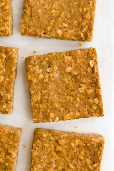 These healthy pumpkin oatmeal bars are perfect for fall! Filled with warm spices and oats — but no eggs and no sugar — these pumpkin bars are really soft and chewy with flavors just like pumpkin pie. These healthy oatmeal bars are also clean eating and vegan with gluten free options! Add this easy pumpkin recipe for baked pumpkin oat bars to your lists of healthy snacks and healthy breakfast ideas to try. It’s the BEST healthy pumpkin bars recipe!