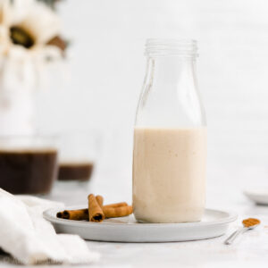 The BEST sugar free gingerbread creamer recipe! This easy homemade coffee creamer adds a taste of gingerbread cookies to your coffee! Made with cozy spices & dairy free milk, this healthy coffee creamer recipe is vegan & clean eating. This DIY coffee creamer also makes your coffee taste like Starbucks holiday drinks! The perfect addition to any Christmas holiday drinks recipe. Save this pin for how to make gingerbread coffee creamer without condensed milk!