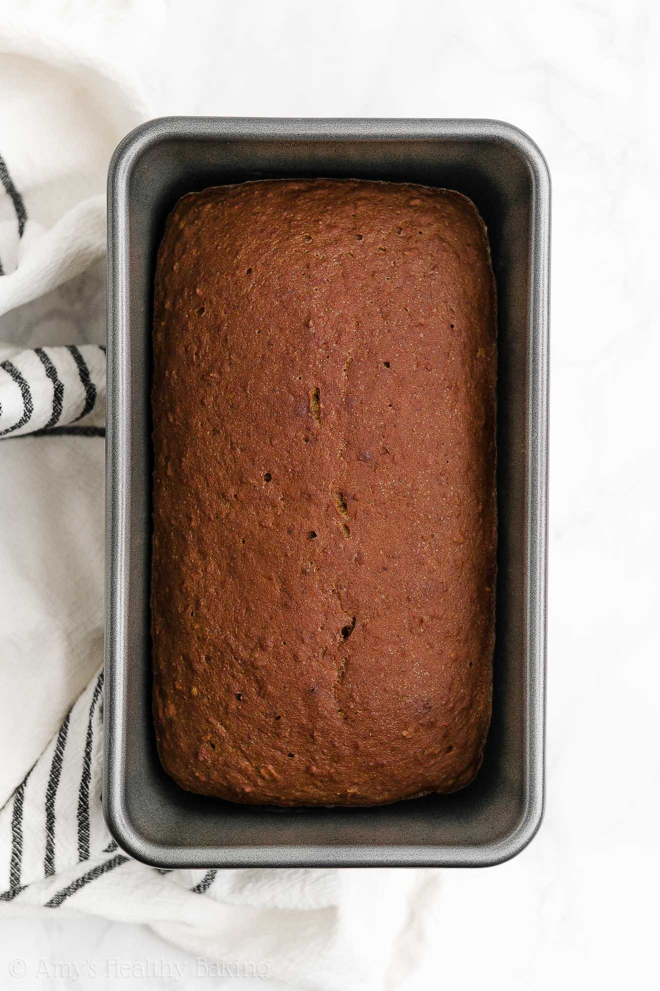 a freshly baked healthy oatmeal gingerbread loaf still in the loaf pan – easy gingerbread quick bread recipe – soft, moist, low fat, low calorie, and clean eating with whole wheat and gluten free options – made with oats, Greek yogurt, molasses, and no refined sugar