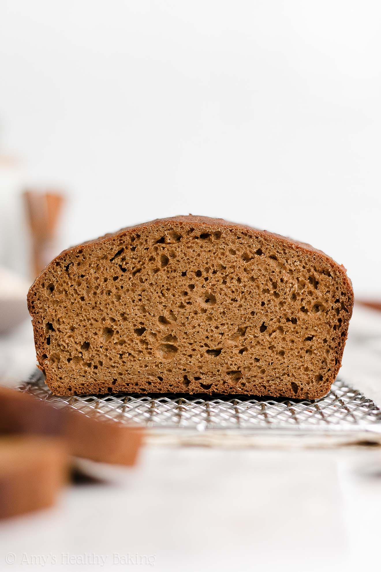 a freshly sliced healthy oatmeal gingerbread loaf on a wire cooling rack – easy gingerbread quick bread recipe – soft, moist, low fat, low calorie, and clean eating with whole wheat and gluten free options – made with oats, Greek yogurt, molasses, and no refined sugar