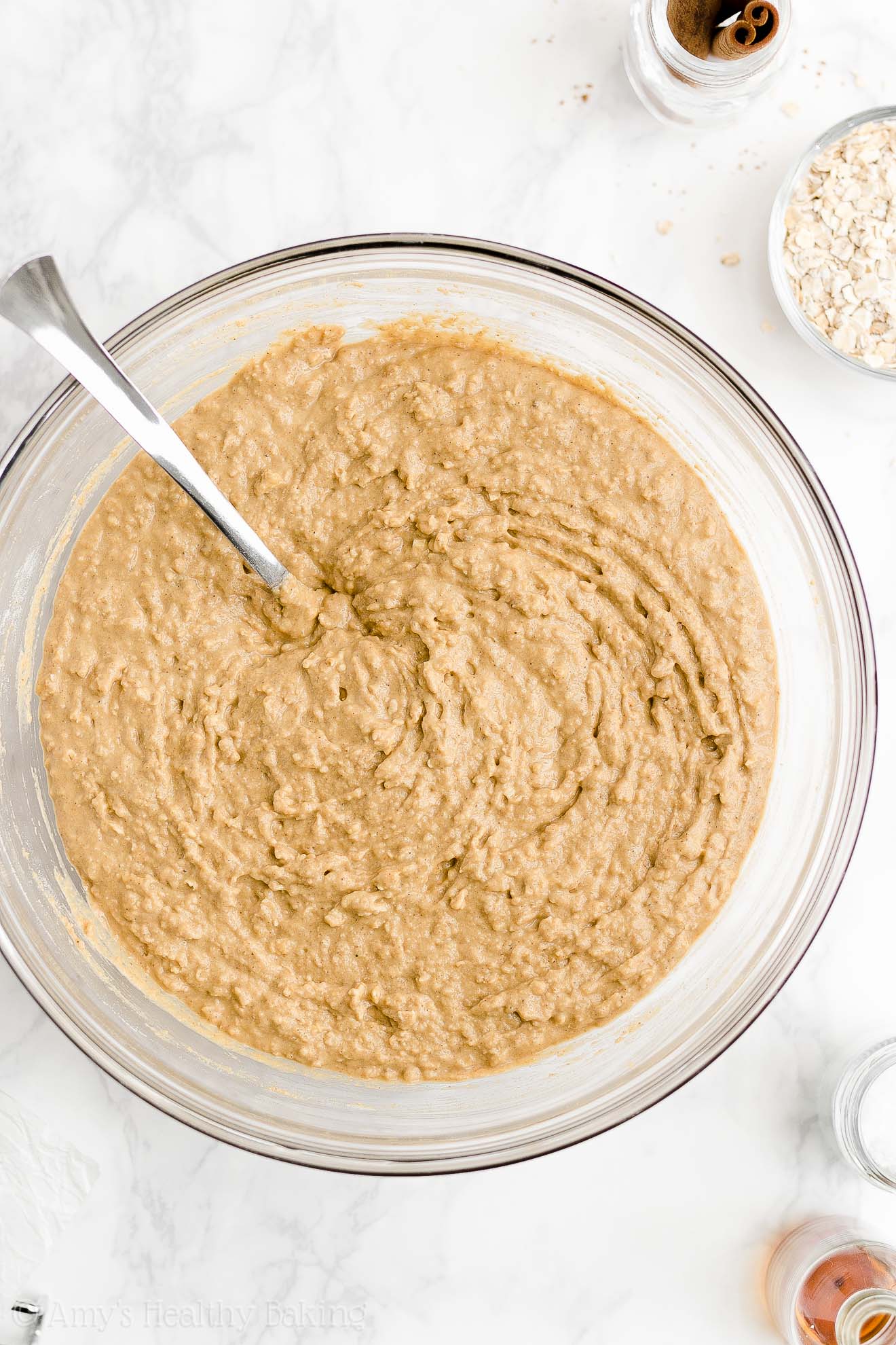 glass mixing bowl holding a fork and the freshly stirred batter used to make a healthy oatmeal gingerbread loaf – easy gingerbread quick bread recipe – soft, moist, low fat, low calorie, and clean eating with whole wheat and gluten free options – made with oats, Greek yogurt, molasses, and no refined sugar