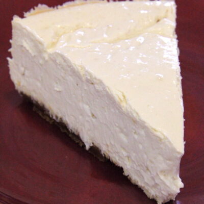 This lightened-up lemon cheesecake is so creamy and easy to make! Lemon yogurt adds more creaminess and an extra boost of citrus flavor, and the filling sits atop a delicious spiced gingersnap cookie crust. A great dessert recipe for spring — or whenever you’re craving cheesecake!